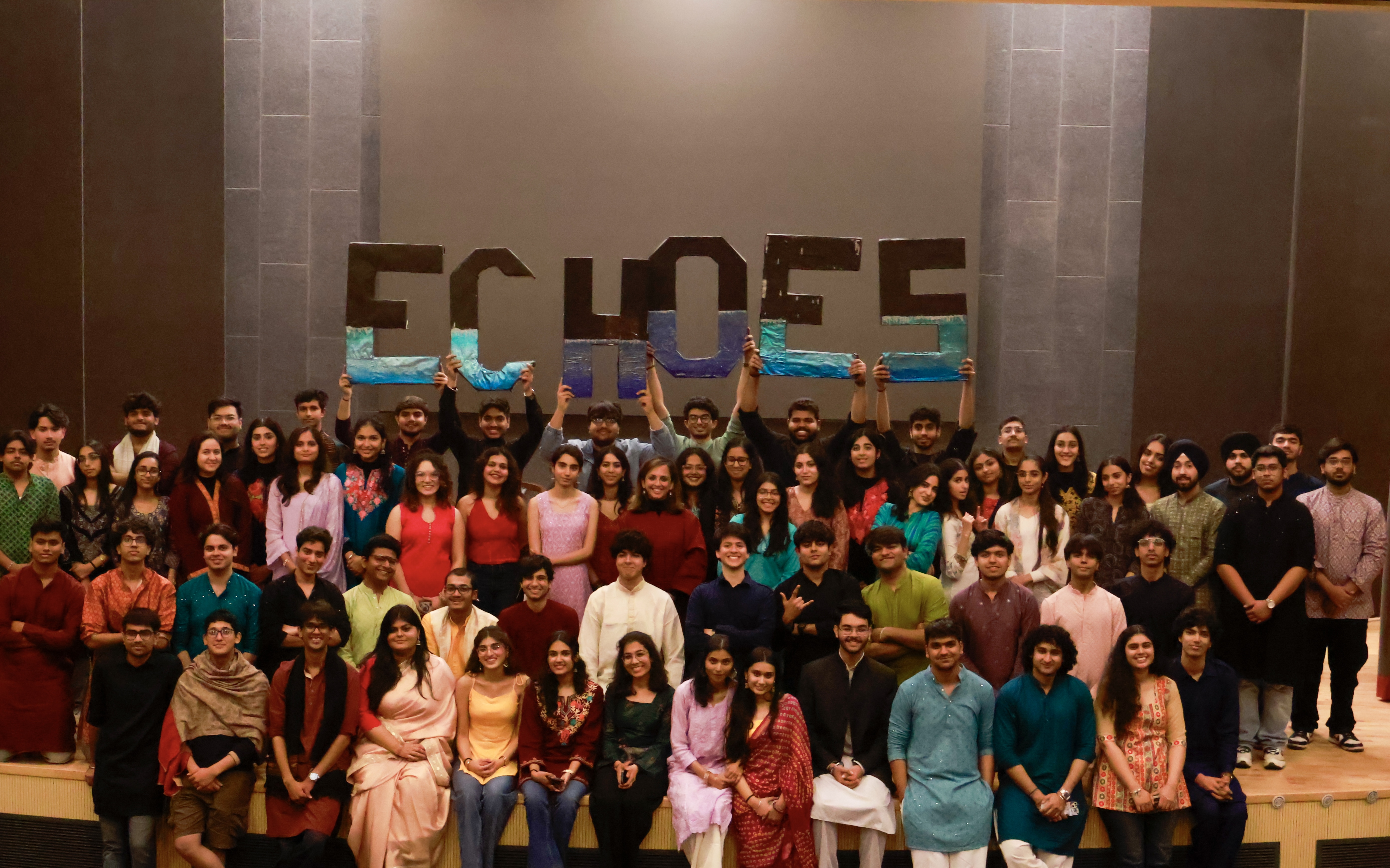Members of the Echoes team gathered on stage, holding up illuminated letters spelling ECHOES